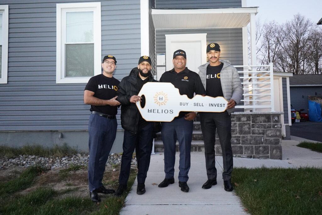 Edwin Diaz, Rafael Rivera Jr., and the Helios Buys NJ team holding a key at a closing