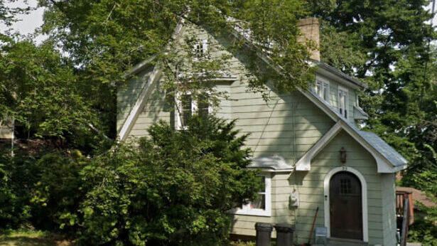 Exterior of New Jersey house before relocation sale showing a property that needed repairs